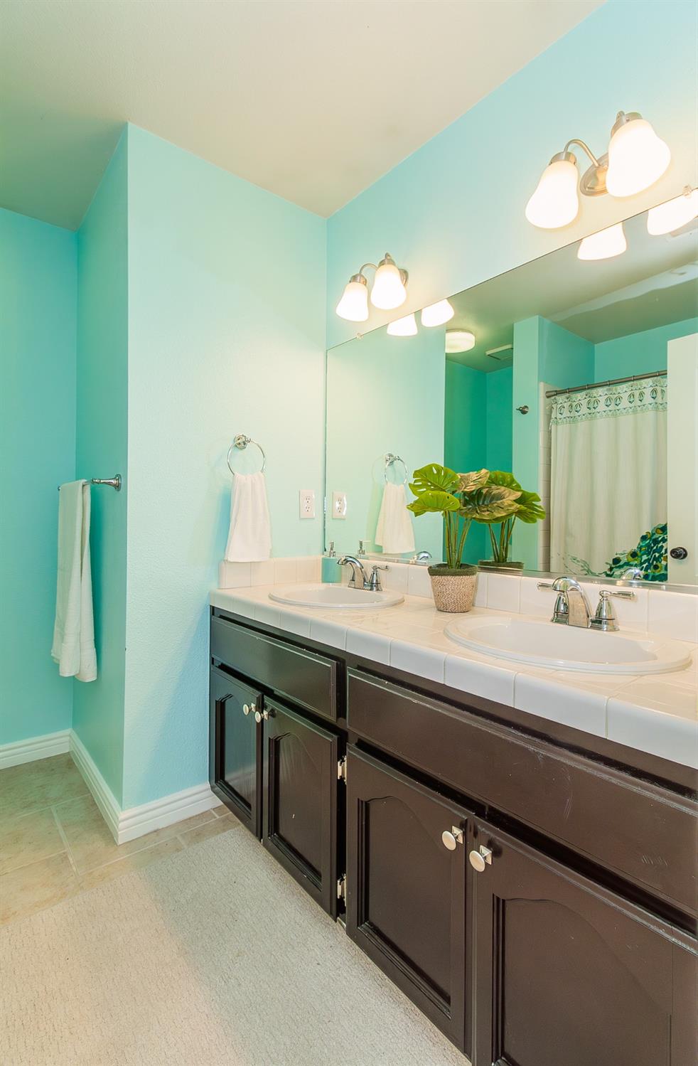 1323 Oak Avenue Clovis, CA 93611 - Photo 24 of 42 a bathroom with a double vanity sink and a mirror