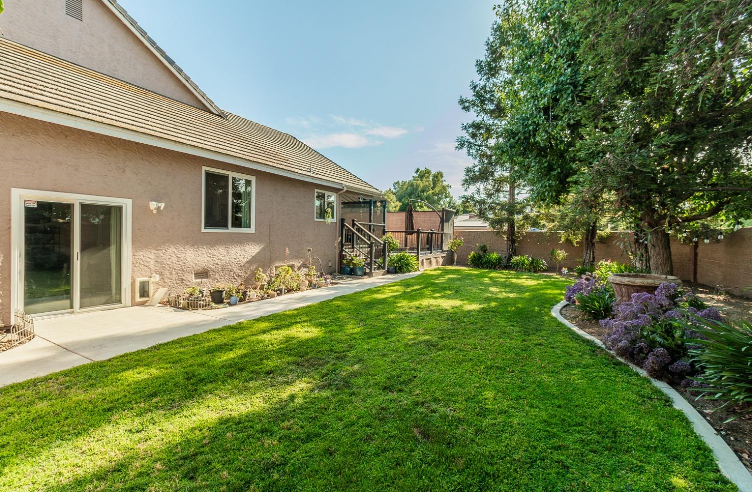 1323 Oak Avenue Clovis, CA 93611 - Photo 31 of 42 a backyard of a house with table and chairs and potted plants