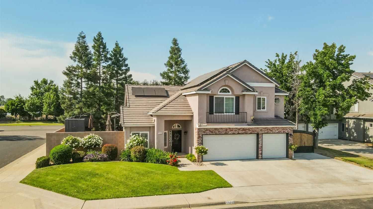 1323 Oak Avenue Clovis, CA 93611 - Photo 32 of 42 a front view of a house with a yard and garage