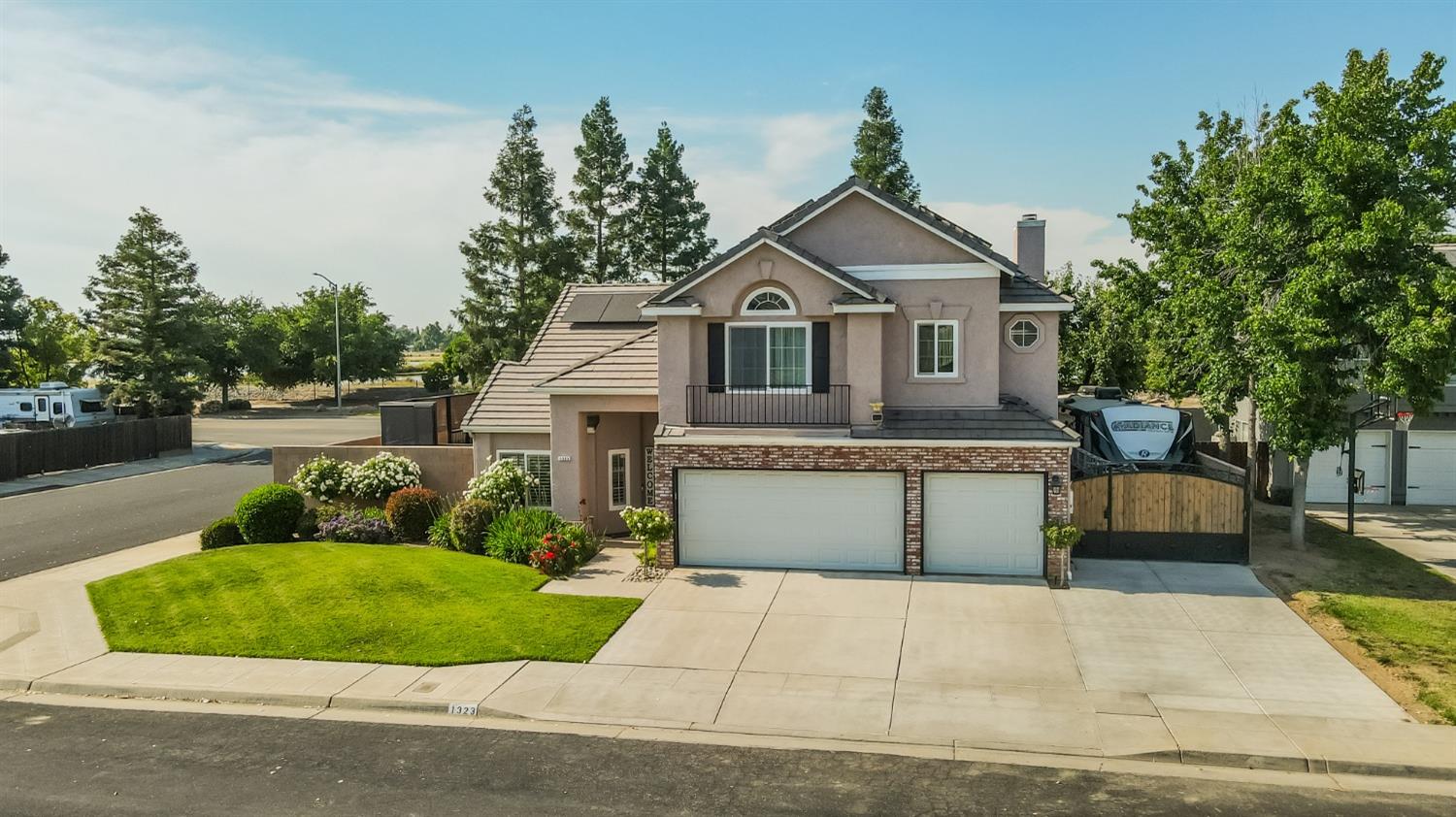 1323 Oak Avenue Clovis, CA 93611 - Photo 33 of 42 a front view of a house with a yard and garage