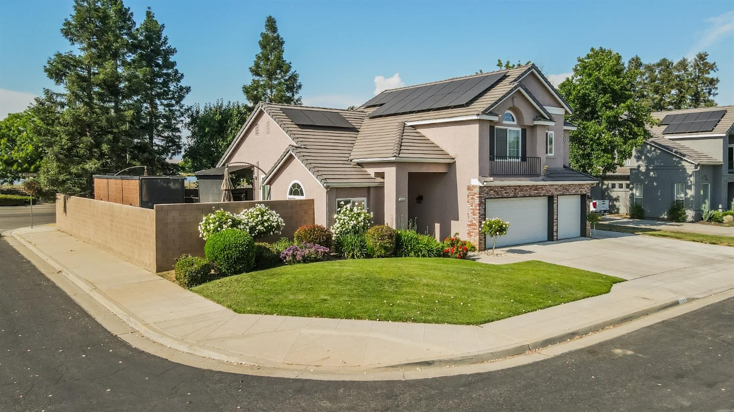 1323 Oak Avenue Clovis, CA 93611 - Photo 35 of 42 a view of a white house with a big yard and potted plants