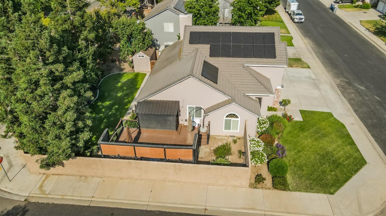 1323 Oak Avenue Clovis, CA 93611 - Photo 40 of 42 a view of a white house with a yard and potted plants