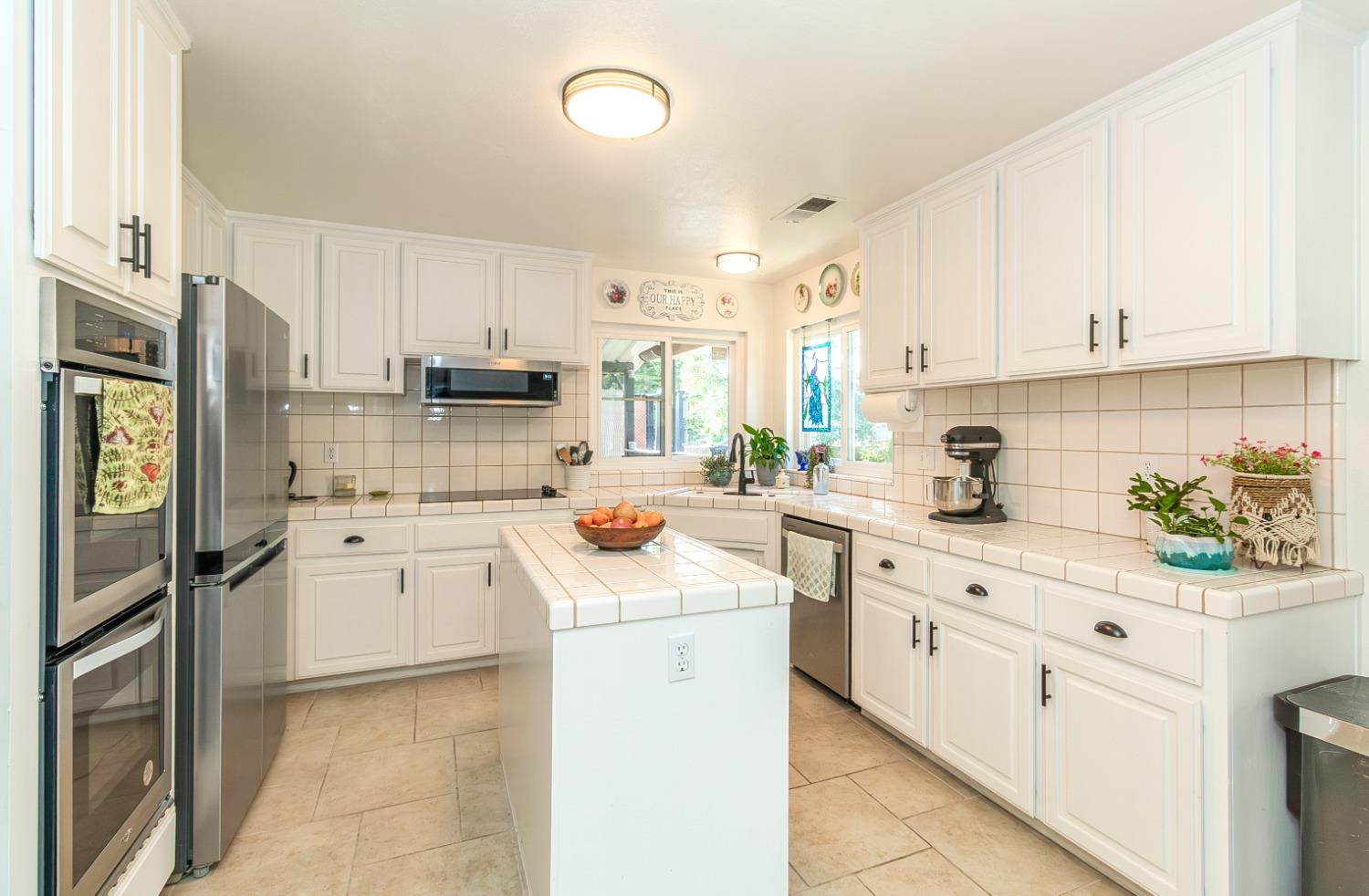 1323 Oak Avenue Clovis, CA 93611 - Photo 9 of 42 a kitchen with cabinets appliances a sink and a counter top space