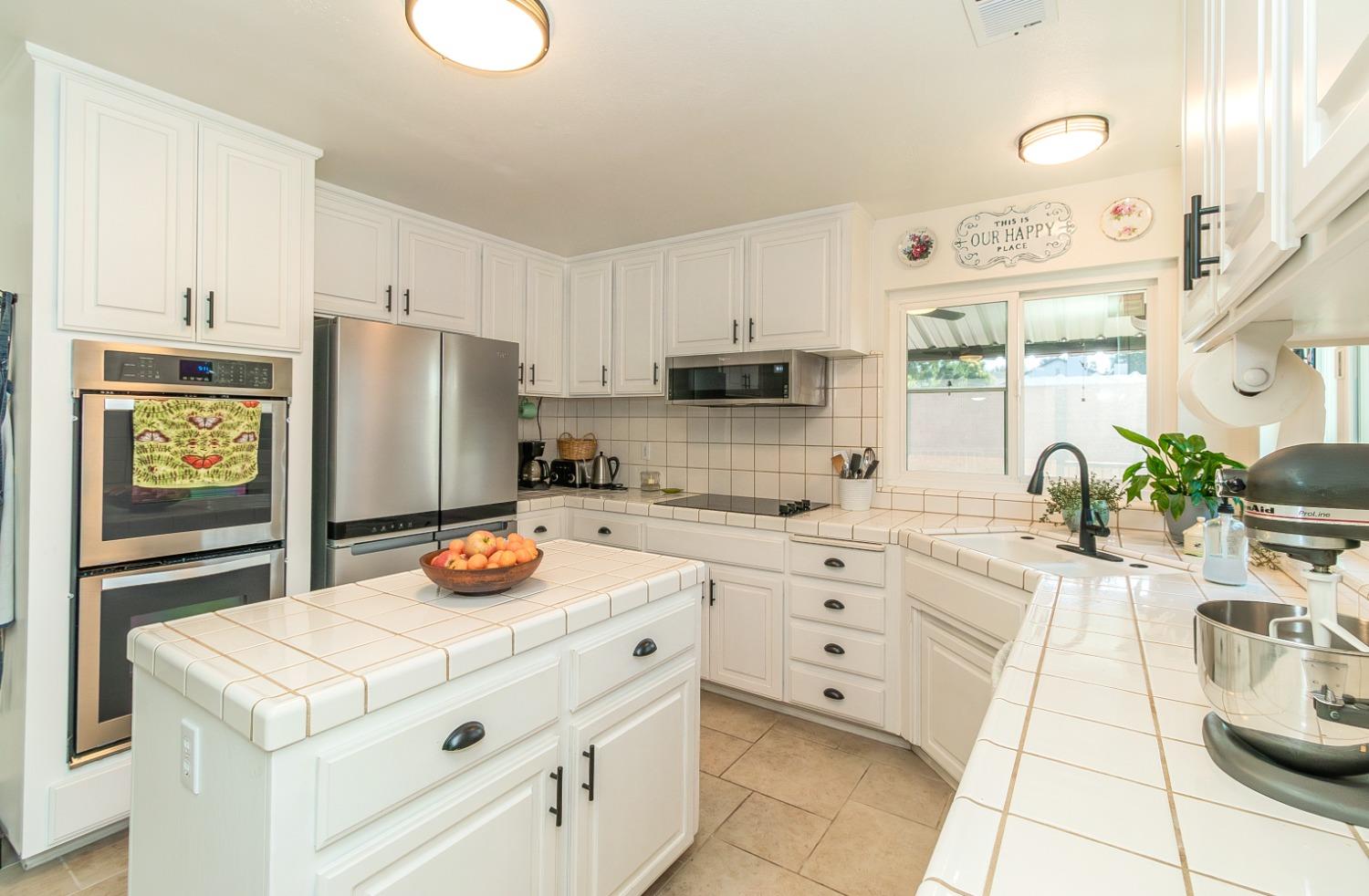 1323 Oak Avenue Clovis, CA 93611 - Photo 10 of 42 a kitchen with stainless steel appliances a refrigerator sink and cabinets