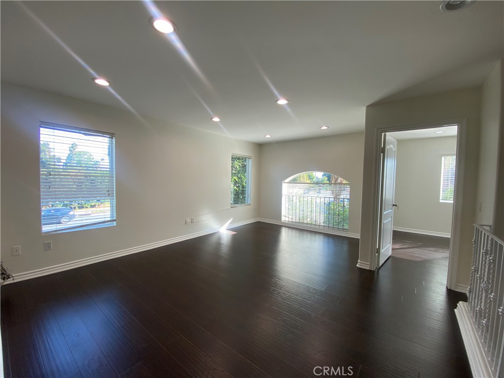 19303 Cohasset Street Reseda, CA 91335 - Photo 11 of 30 an empty room with wooden floor and windows