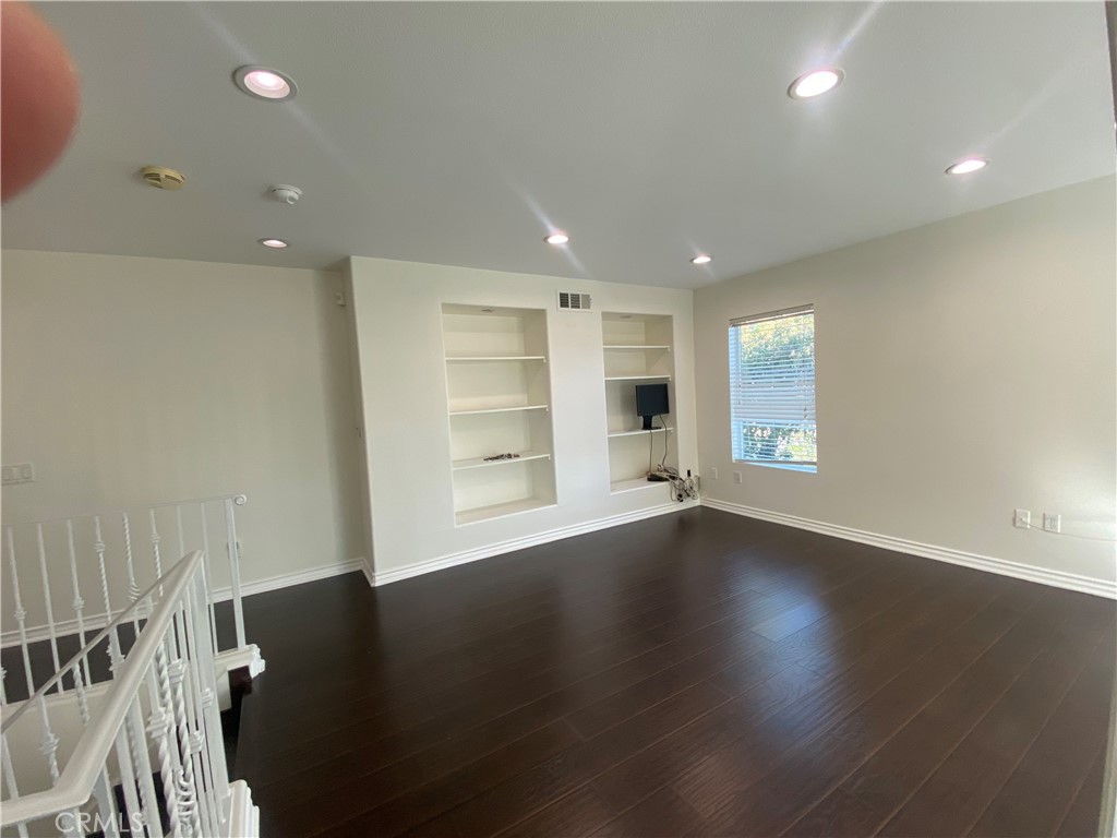 19303 Cohasset Street Reseda, CA 91335 - Photo 12 of 30 an empty room with wooden floor and windows