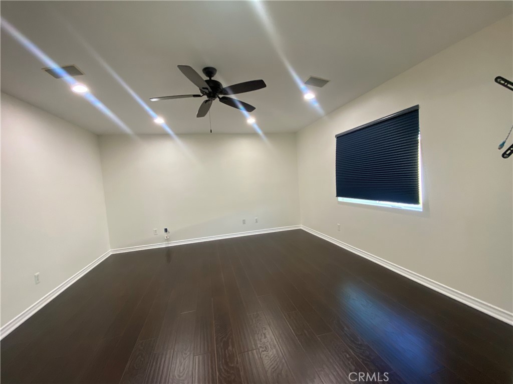 19303 Cohasset Street Reseda, CA 91335 - Photo 14 of 30 an empty room with wooden floor fan and windows
