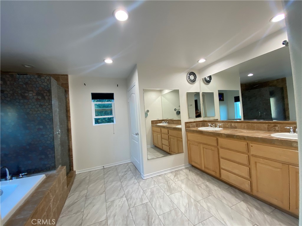 19303 Cohasset Street Reseda, CA 91335 - Photo 17 of 30 a large bathroom with a large tub and sink