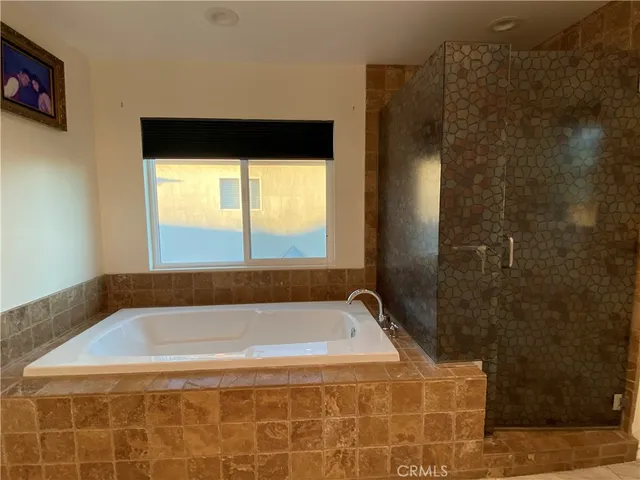 a bathroom with a granite countertop sink mirror and shower