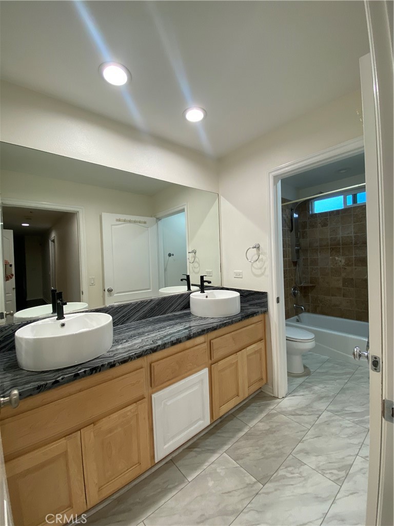 19303 Cohasset Street Reseda, CA 91335 - Photo 20 of 30 a bathroom with a granite countertop sink mirror and shower