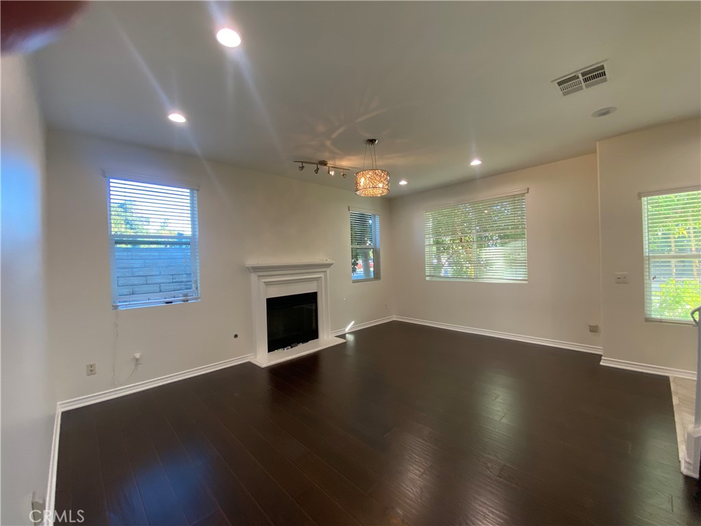 19303 Cohasset Street Reseda, CA 91335 - Photo 2 of 30 an empty room with wooden floor and windows