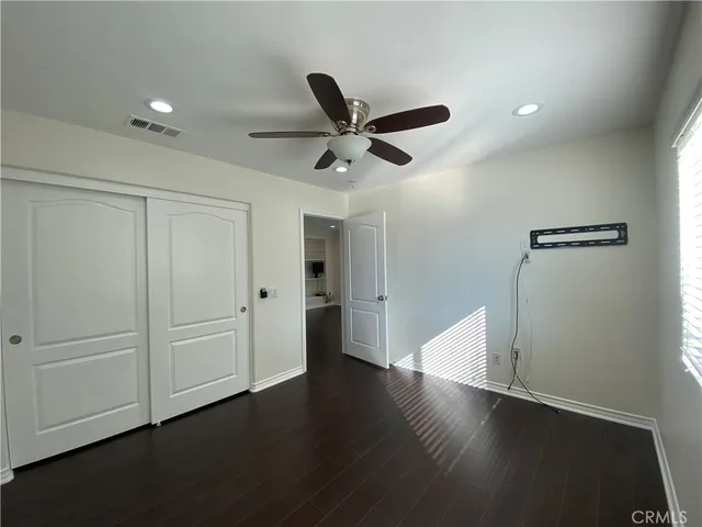 a view of a livingroom with an empty space & wooden floor