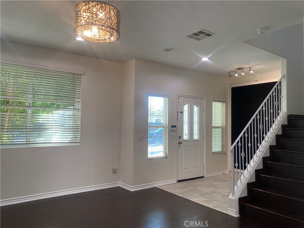 19303 Cohasset Street Reseda, CA 91335 - Photo 4 of 30 a view of an empty room with wooden floor and a window