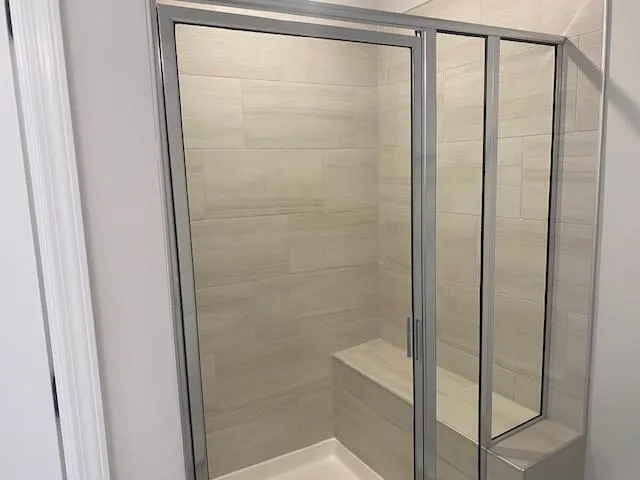 a bathroom with a glass shower door