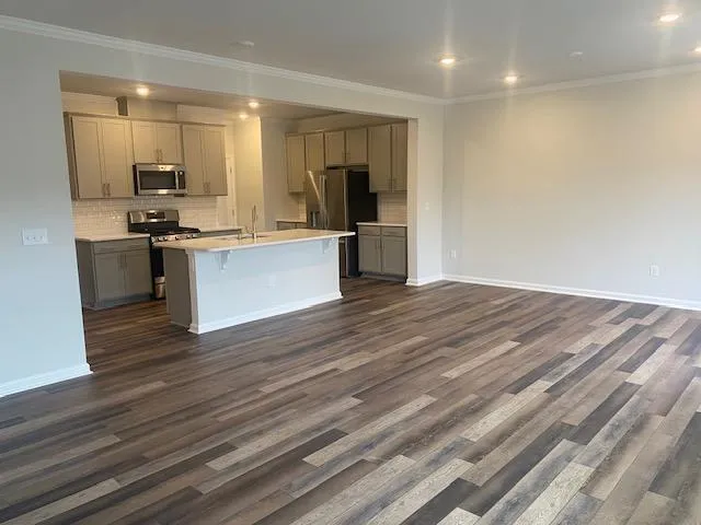 a large kitchen with kitchen island a sink stainless steel appliances and cabinets