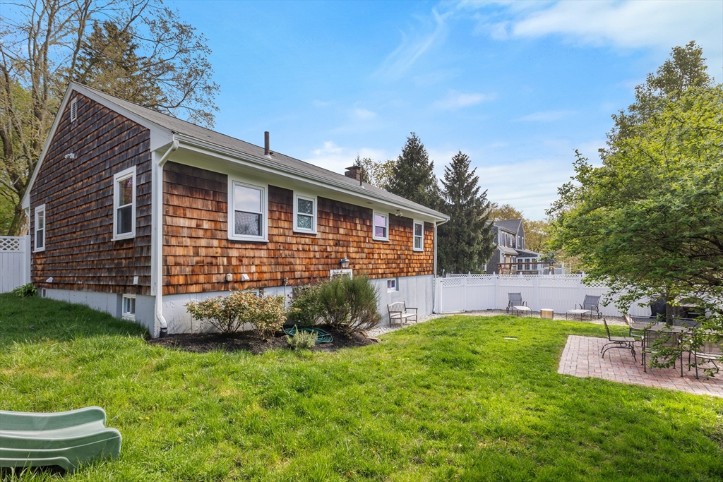 21 Linscott Road Hingham, MA 02043 - Photo 11 of 32 a view of a backyard with plants and large tree