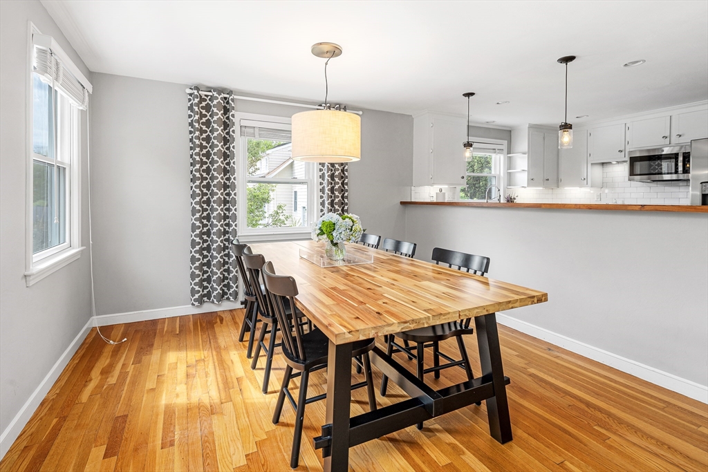 21 Linscott Road Hingham, MA 02043 - Photo 19 of 32 a kitchen with a table chairs and wooden floor