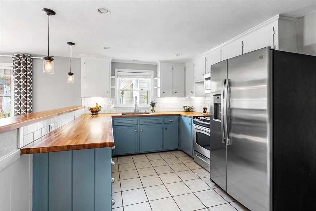 21 Linscott Road Hingham, MA 02043 - Photo 20 of 32 a kitchen with stainless steel appliances kitchen island granite countertop a refrigerator and a sink