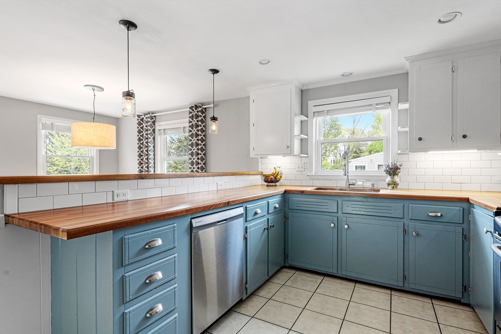 21 Linscott Road Hingham, MA 02043 - Photo 21 of 32 a kitchen with a sink window and cabinets