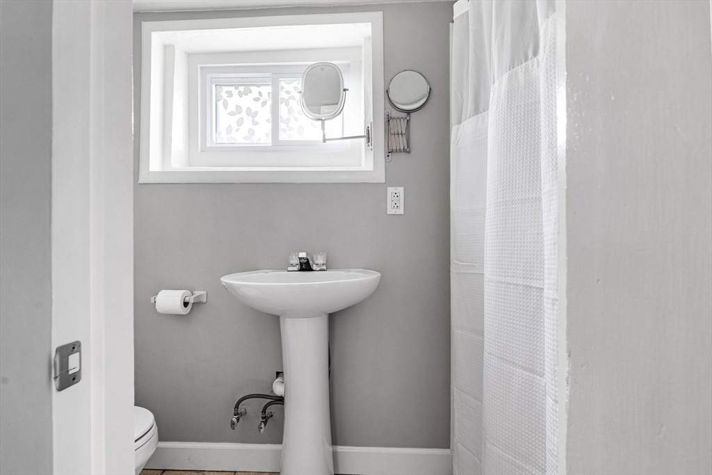21 Linscott Road Hingham, MA 02043 - Photo 32 of 32 a bathroom with a sink a toilet and a window