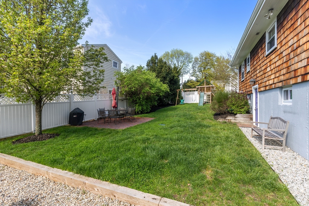 21 Linscott Road Hingham, MA 02043 - Photo 8 of 32 a view of a backyard with a garden and plants