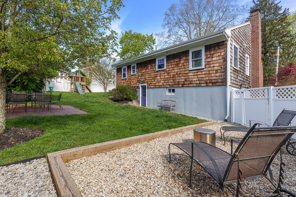 21 Linscott Road Hingham, MA 02043 - Photo 9 of 32 a view of a backyard with table and chairs and a barbeque