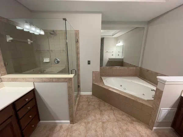 a bathroom with a granite countertop sink a toilet and shower