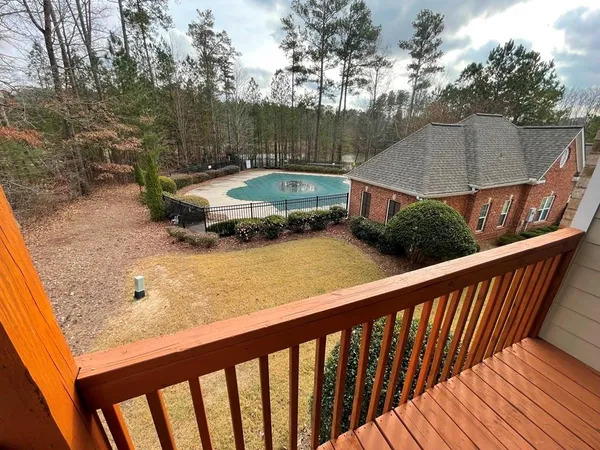 a view of a wooden deck and a backyard