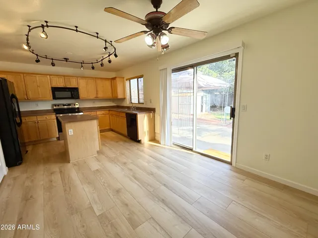a view of a kitchen with a sink and wooden floor