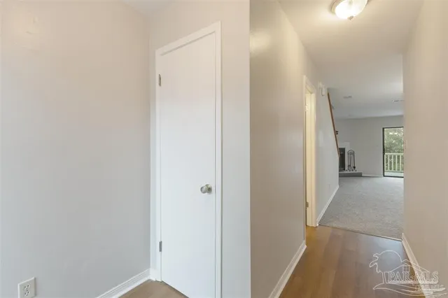 a view of a hallway with wooden shelves