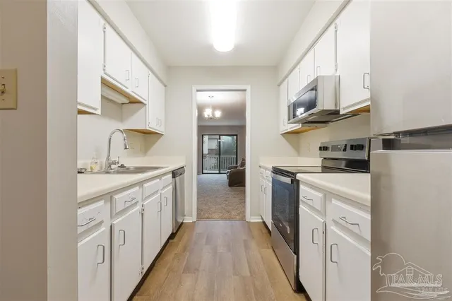 a kitchen with cabinets and stainless steel appliances