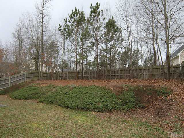 429 Hay River Street Garner, NC 27529 - Photo 11 of 12 a view of outdoor space with deck and trees