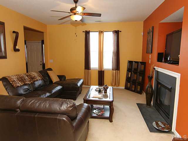 429 Hay River Street Garner, NC 27529 - Photo 3 of 12 a living room with furniture and a fireplace