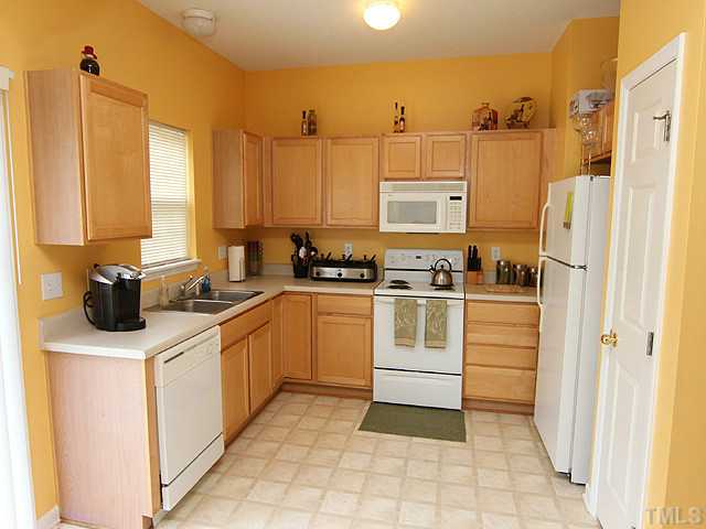 429 Hay River Street Garner, NC 27529 - Photo 5 of 12 a kitchen with stainless steel appliances a stove a sink and a refrigerator