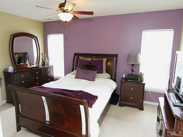 429 Hay River Street Garner, NC 27529 - Photo 7 of 12 a bedroom with a bed and a dresser