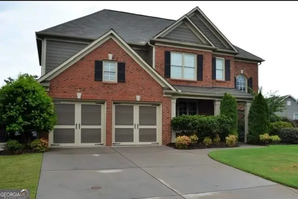 a front view of a house with a yard and garage