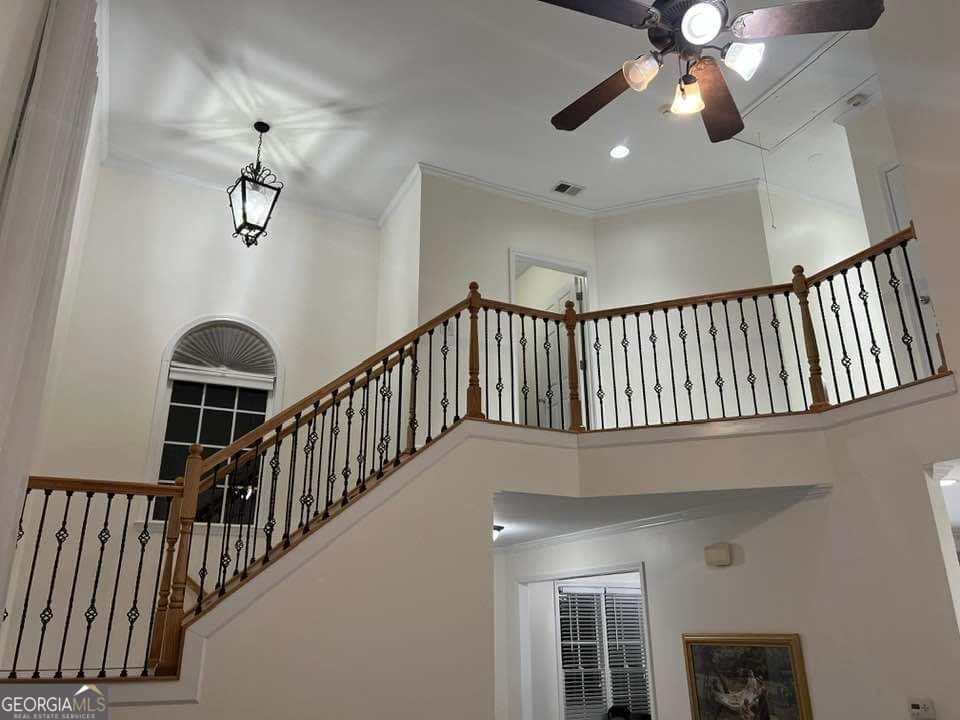67 Cherokee Rose Run Dallas, GA 30157 - Photo 2 of 3 a view of staircase with railing and a chandelier