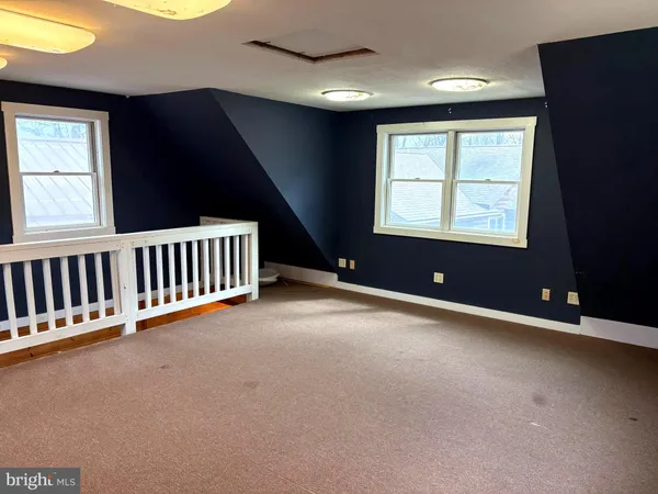 an empty room with windows and entrance