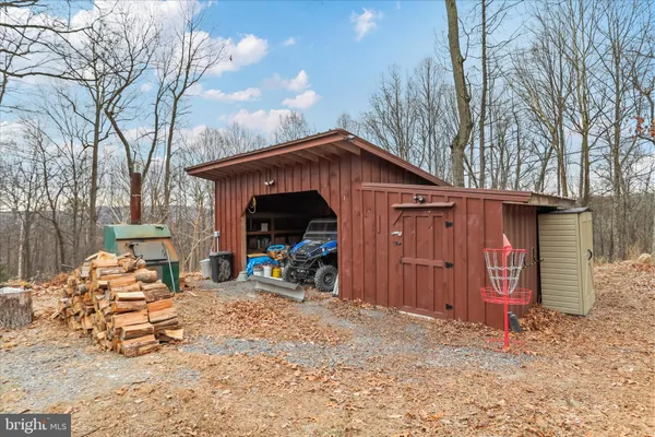 a view of a dry yard with mountains in the background