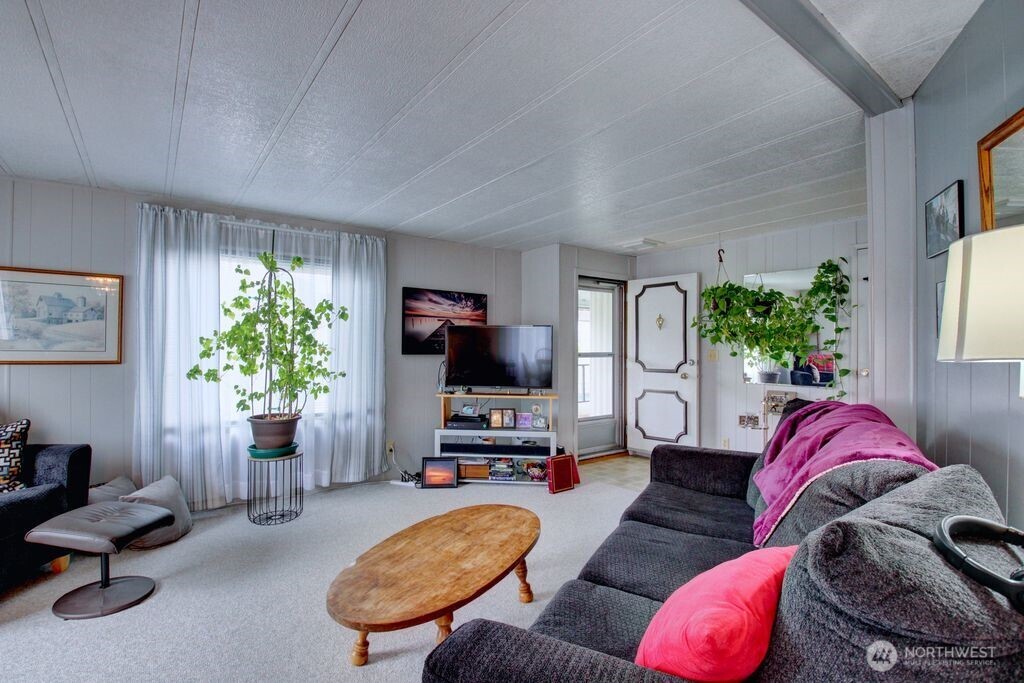 920 Maple Street, Unit 3 Sedro-Woolley, WA 98284 - Photo 11 of 18 a living room with furniture and a flat screen tv