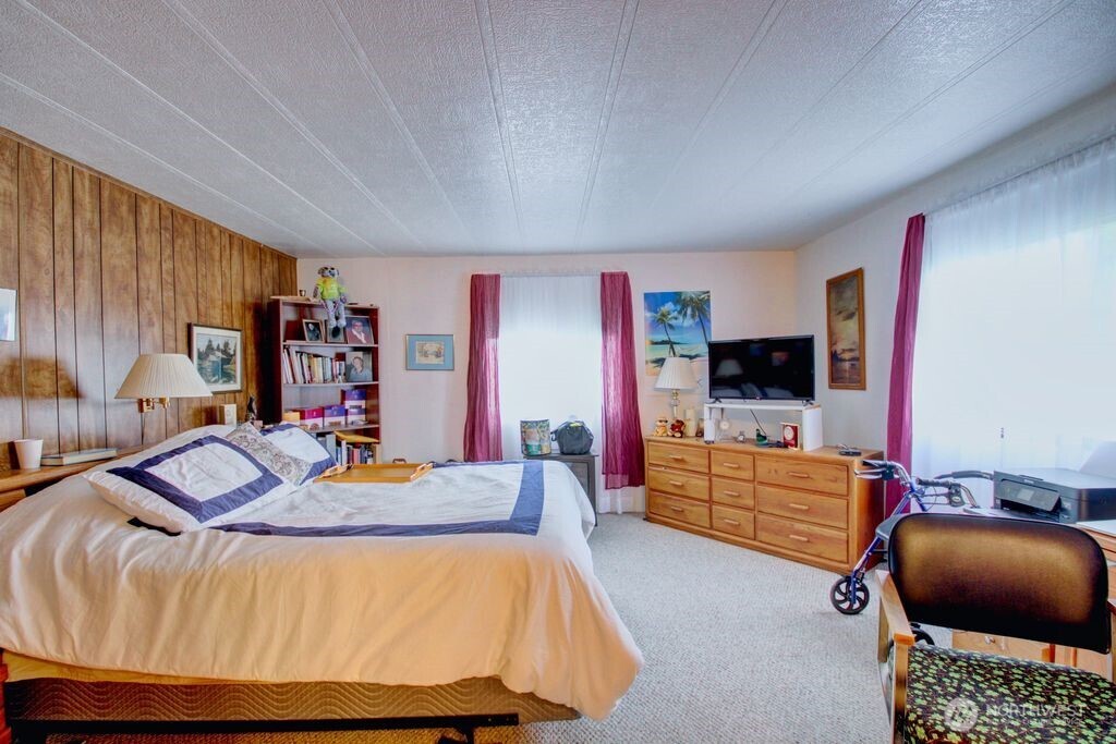 920 Maple Street, Unit 3 Sedro-Woolley, WA 98284 - Photo 15 of 18 a bedroom with furniture and a flat screen tv