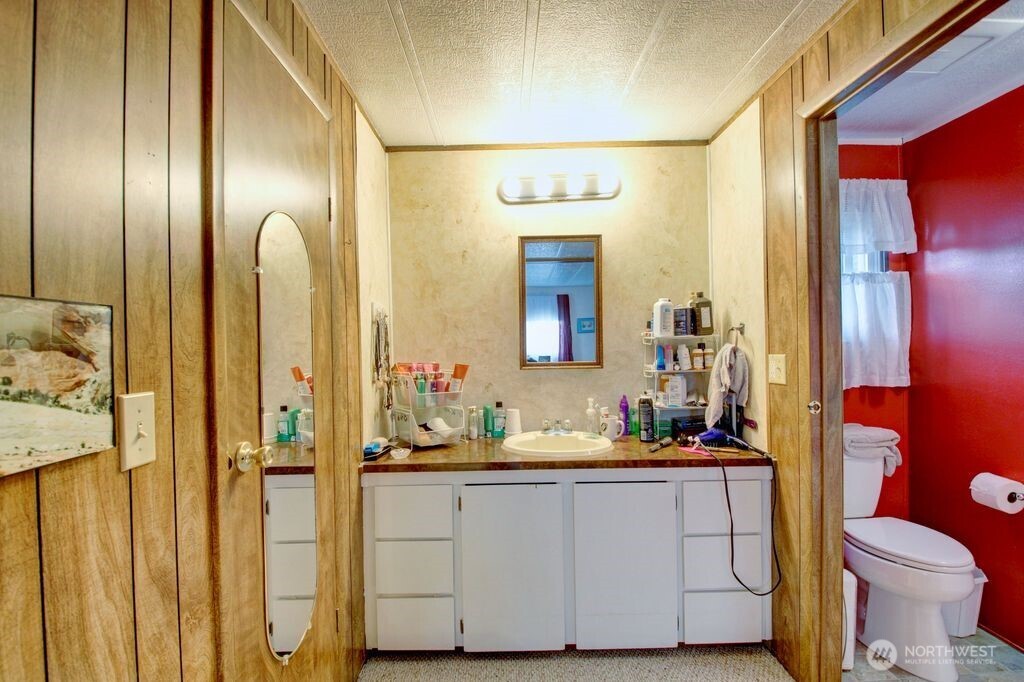 920 Maple Street, Unit 3 Sedro-Woolley, WA 98284 - Photo 16 of 18 a bathroom with a granite countertop sink and a mirror