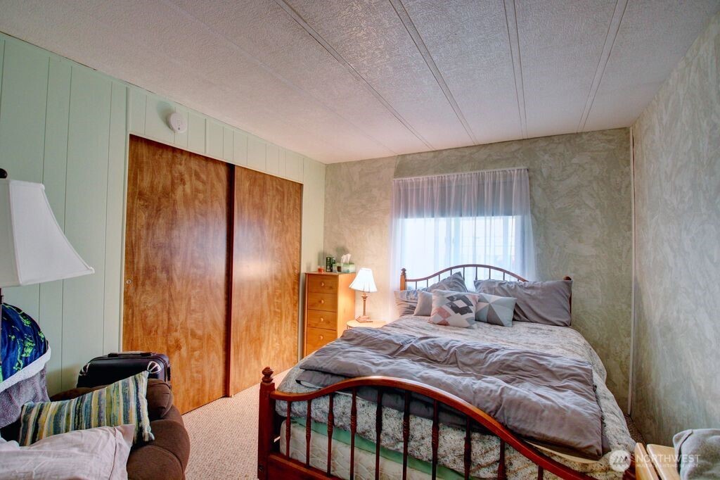 920 Maple Street, Unit 3 Sedro-Woolley, WA 98284 - Photo 17 of 18 a bedroom with a bed and wooden floor