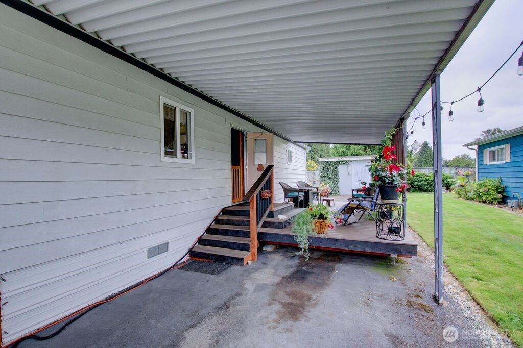 920 Maple Street, Unit 3 Sedro-Woolley, WA 98284 - Photo 5 of 18 a backyard of a house with lots of green space tables and chairs