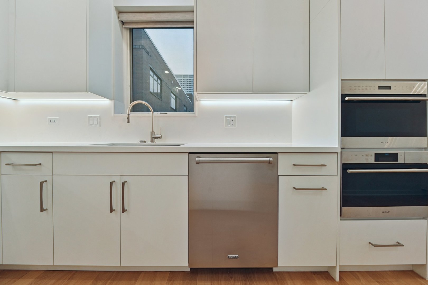 1640 South Prairie Avenue Chicago, IL 60616 - Photo 13 of 34 a kitchen with a sink and a stove with white stainless steel appliances