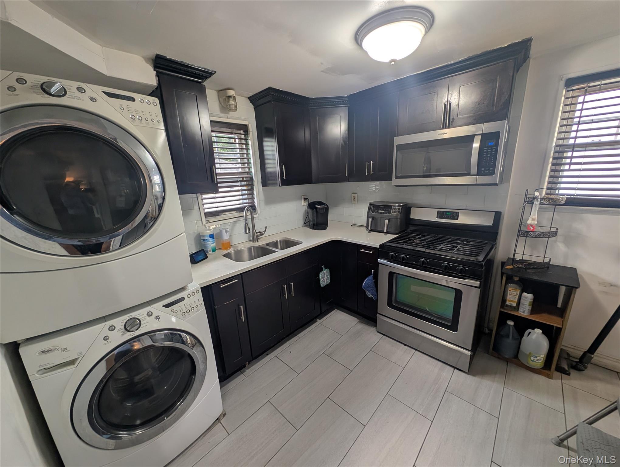 81 Cochran Place Valley Stream, NY 11581 - Photo 3 of 12 a kitchen with a washer and dryer in it