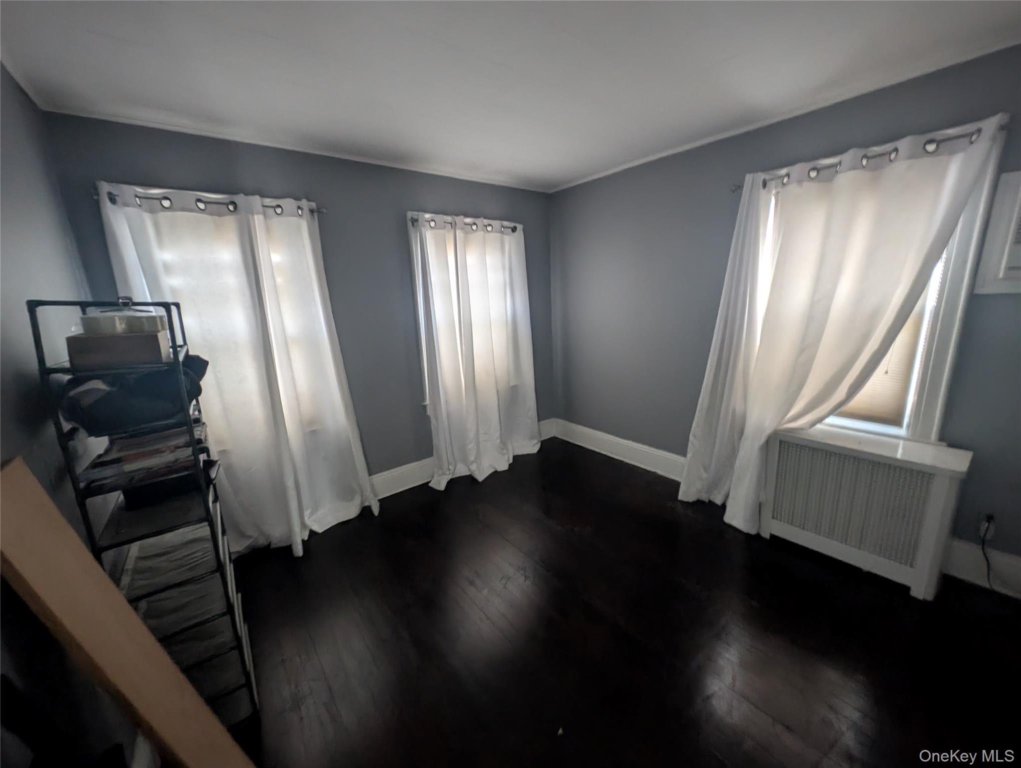 81 Cochran Place Valley Stream, NY 11581 - Photo 7 of 12 a view of a hallway with wooden floor and chair