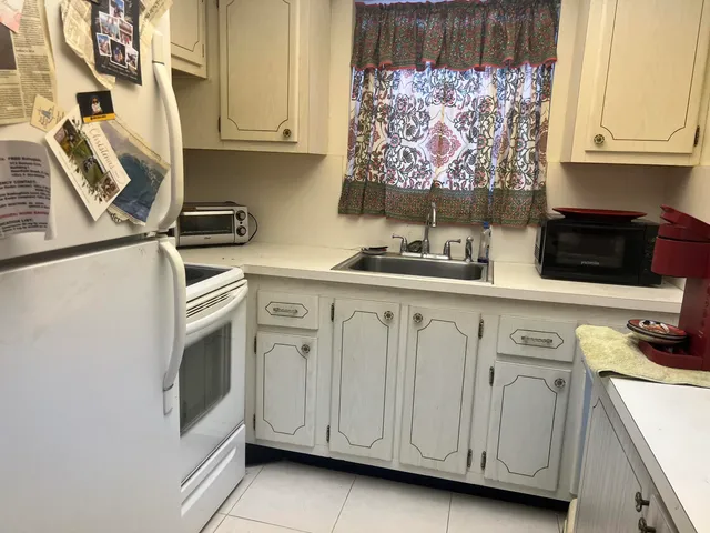 a kitchen with stainless steel appliances white cabinets and a sink