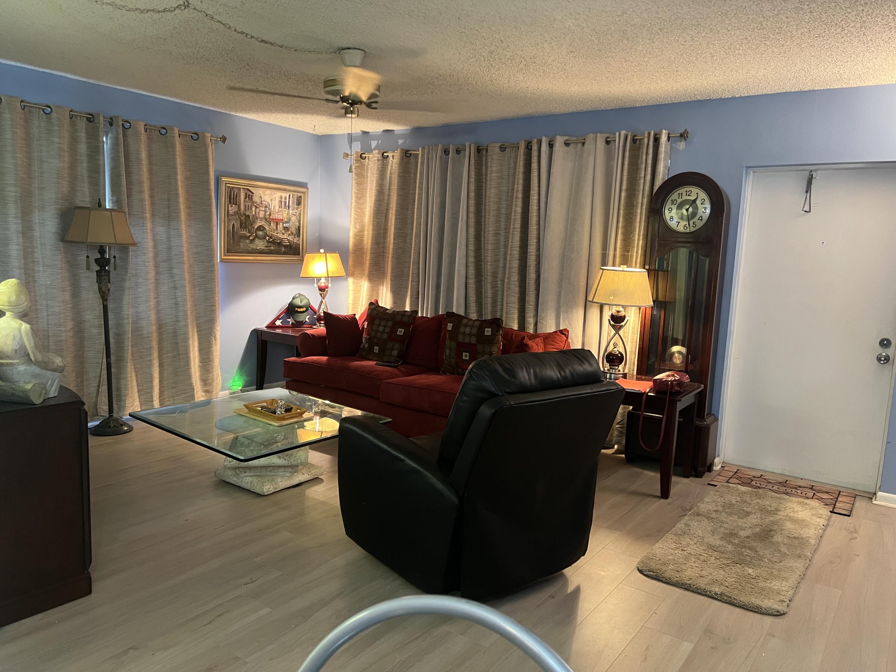 313 Durham Circle Deerfield Beach, FL 33442 - Photo 4 of 9 a living room with furniture and wooden floor