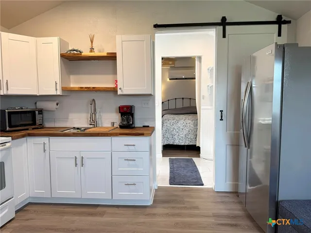 a kitchen with stainless steel appliances a refrigerator and cabinets